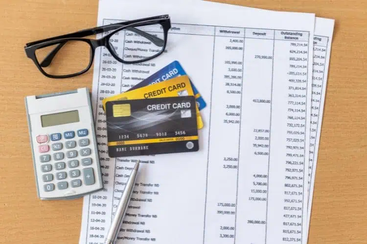 Bank Statement Documents with Credits Cards, Glasses, a Pen and Calculator